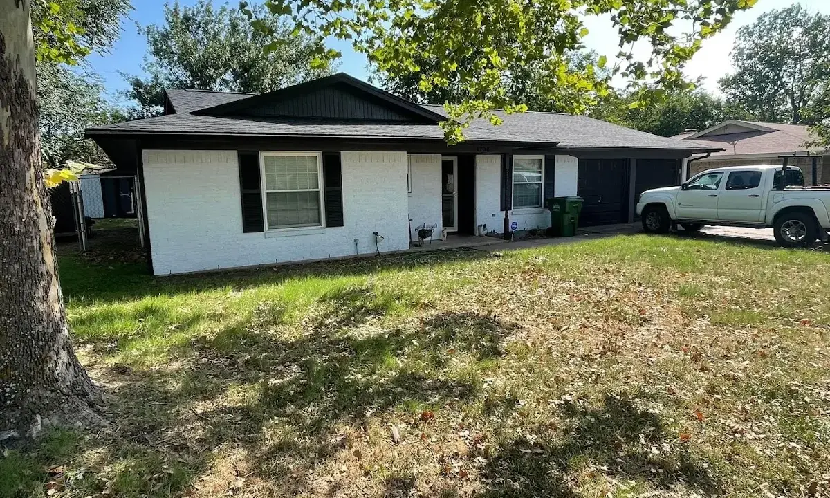 Professional roofing crew working on a residential roof in Munford